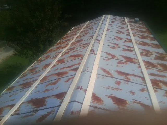 Rusted metal roof panels with new wood purlins before replacement — Storm Damage Roof Repair in Wood Dale by Roofing Brothers