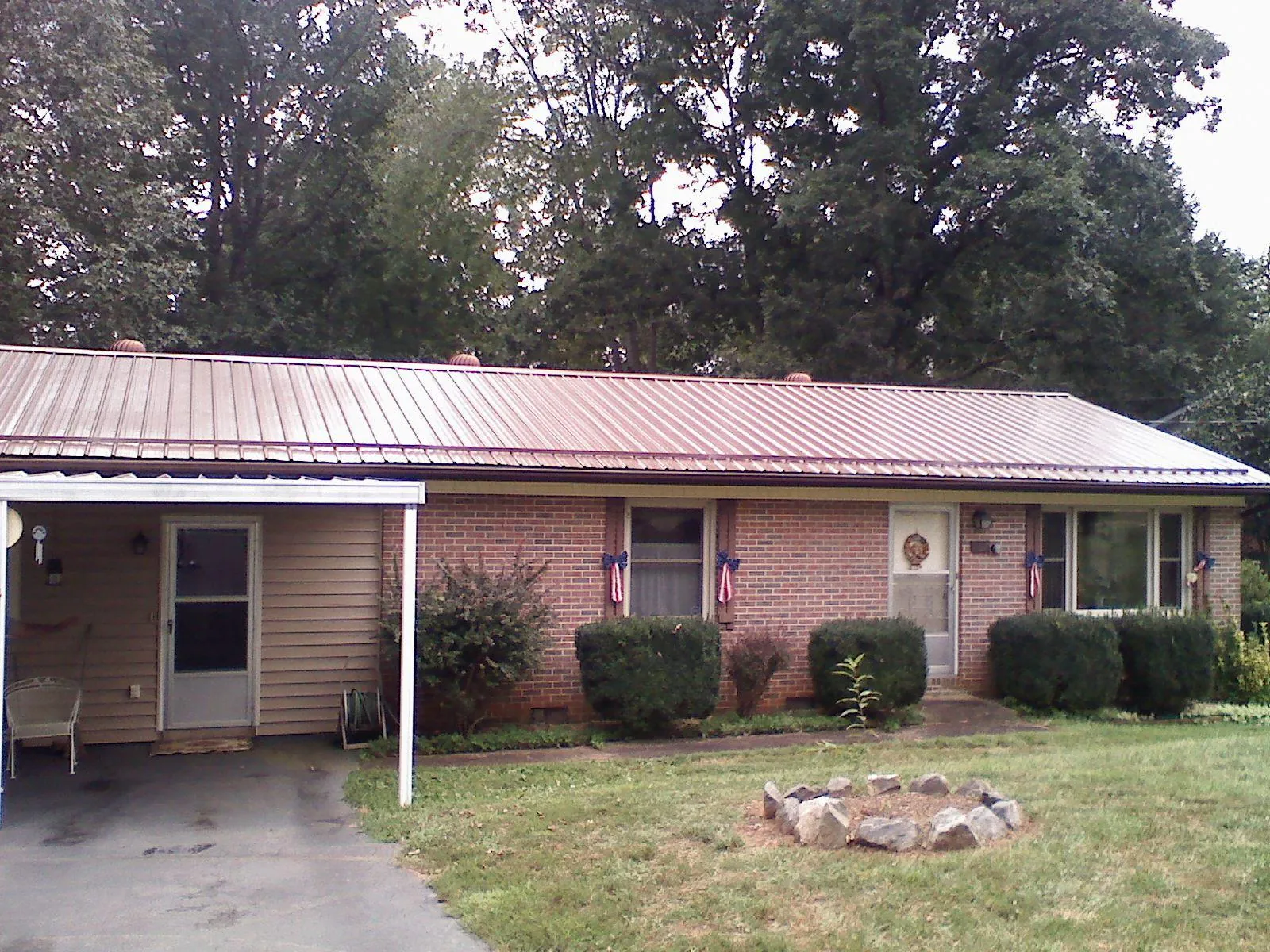 Bronze metal roof and carport on a brick ranch home — Roof Repair work by our crew in Wood Dale