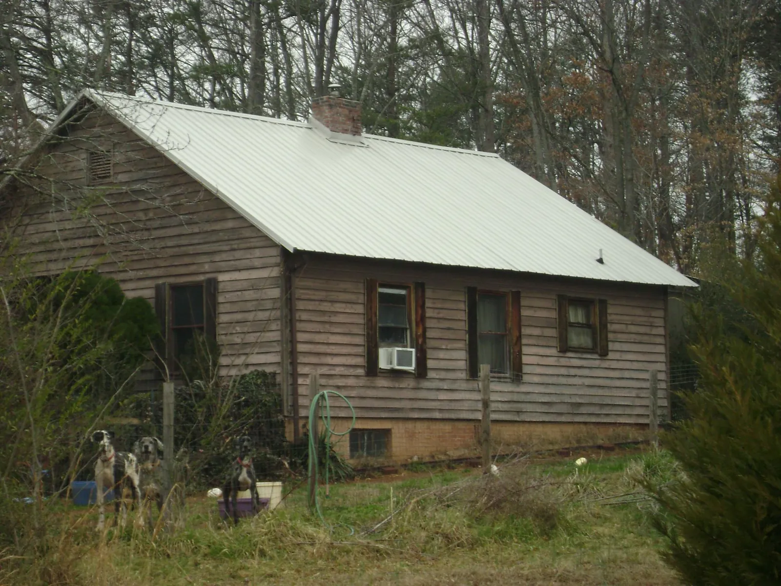 White metal roof on an old wood sided farmhouse, from a Metal Roof Installation job in Wood Dale